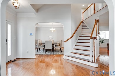 Large Foyer with Newly Refinished Hardwood Floors, Architectural Designed Quarter-Turn Staircase, Arched Entryways