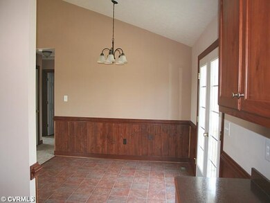 Dining Room - The kitchen opens to the vaulted din