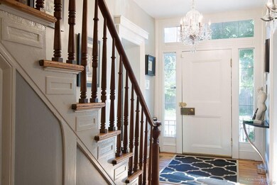 Bright and inviting front hall  highlighted by spi