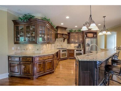 Impressive walnut cabinetry, walk-in pantry, grani