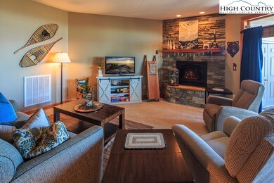 large living area with stacked stone fireplace