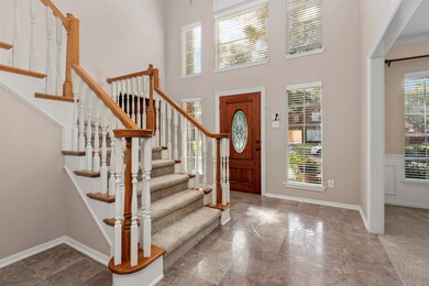 The 2-story entry boasts elegant marble flooring.