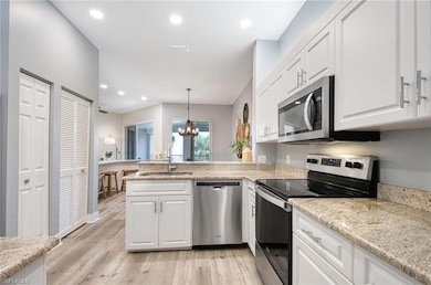 Kitchen with sink, an inviting chandelier, decorat