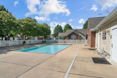 Community pool with a patio