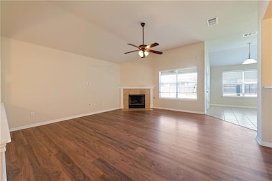 Unfurnished living room featuring a ceiling fan, 