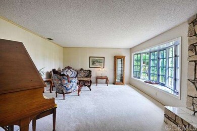 Spacious living room with bay windows.