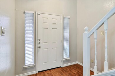 Foyer leading into living area and upstairs to the