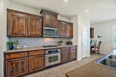 Kitchen featuring a sink, light tile patterned flo