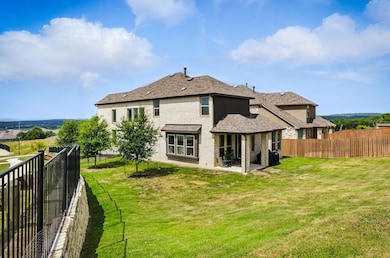 Back of house with a fenced backyard, a patio are