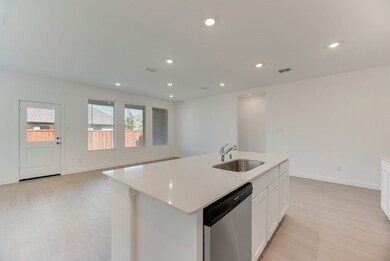 Kitchen featuring dishwasher, light wood-type flooring, light countertops, white cabinetry, and a kitchen island with sink