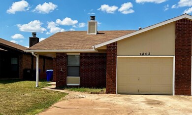 View of front facade with a front yard and a garag