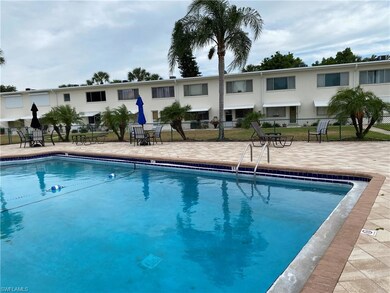 Community pool with fence and a patio area