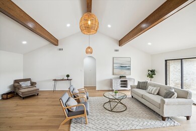 Airy living room with rattan lighting, a vaulted c