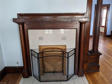 The living room features a classic decorative fireplace.