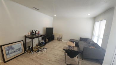 Living area with light wood-style floors, recesse