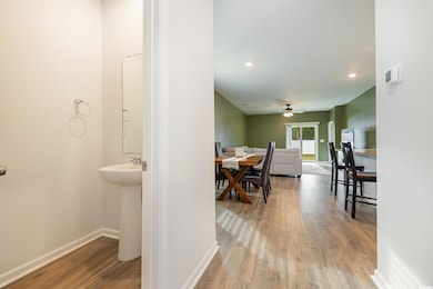 Corridor featuring wood finished floors, baseboard