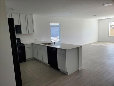 Kitchen with a peninsula, light wood-type flooring