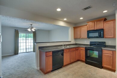 The Kitchen opens into the Living Room. 