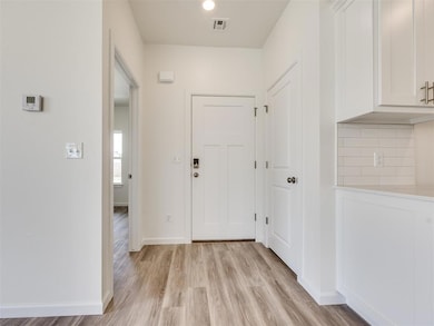 Hallway featuring light wood-type flooring