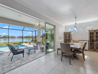 Dining room with a sunroom, a water view, ceiling