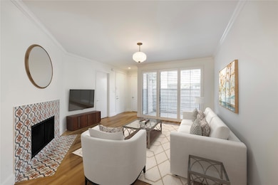Bright living room with crown molding, new flooring, and views to the private patio. Virtually staged.