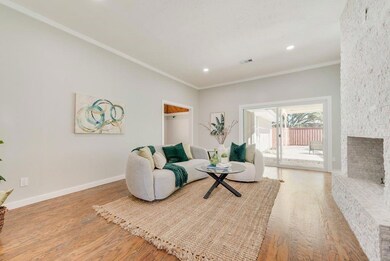 Living room with ornamental molding, a fireplace, 