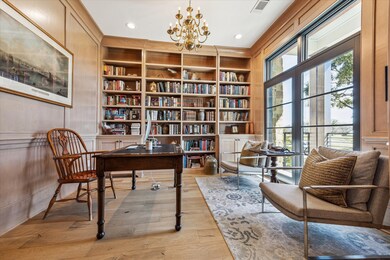 Library with wall of bookshelves overlooks the fro