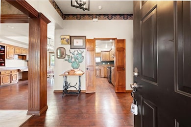 Entryway featuring dark wood-style flooring and a chandelier
