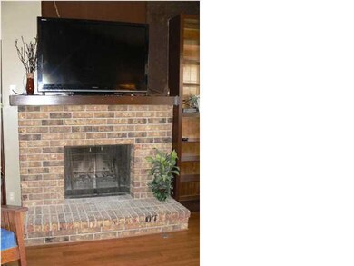 The lovely brick wood-burning fireplace flanked by