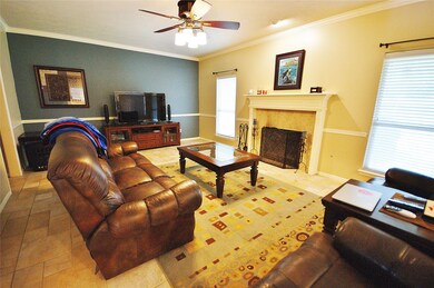 HUGE DEN WITH CROWN MOULDING AND GAS STARTER WOOD BURNING FIREPLACE.  RANDOM PATTERN TILE FLOOR.