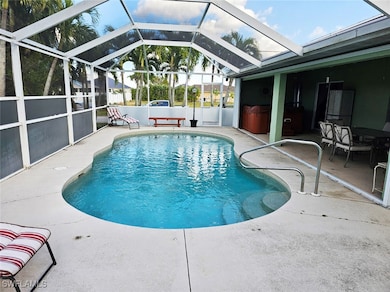 View of swimming pool with glass enclosure, a jacuzzi, and a patio