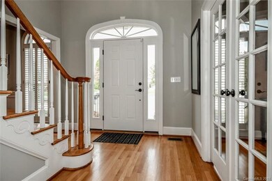 Curved transom window over front entrance with sid