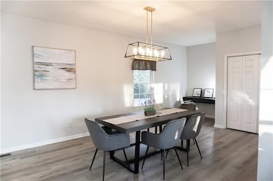 Dining area featuring visible vents, wood finished