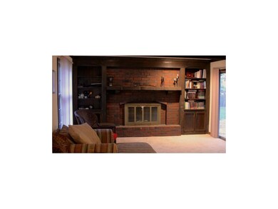 Cozy fireplace in Family Room with entrance to dec