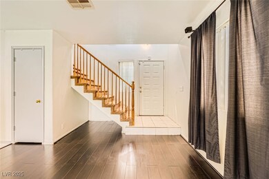 Foyer with wood finished floors and stairs