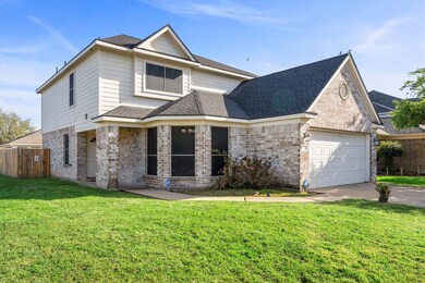This charming two-story home features a brick and