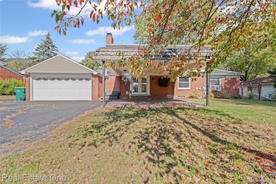 Ranch-style home featuring a patio area, brick siding, a pergola, a garage, and a front yard