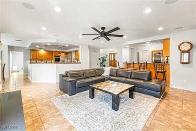 Living area featuring recessed lighting, ceiling fan, and light tile patterned flooring