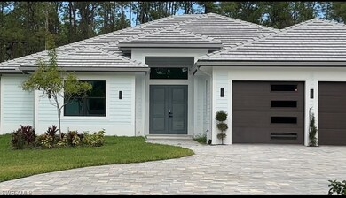 View of front of home with an attached garage, a t