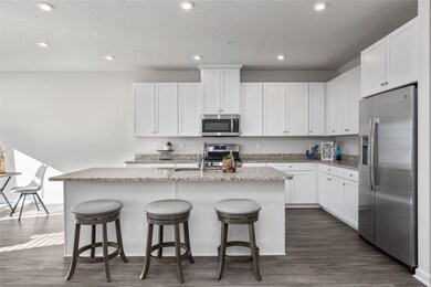 Gleaming white cabinetry is shown here with soft c