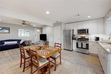 Kitchen with stainless steel appliances, a sink, l