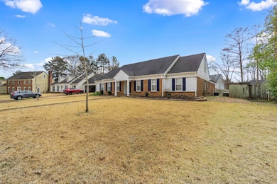 View of front of house featuring brick siding, a f