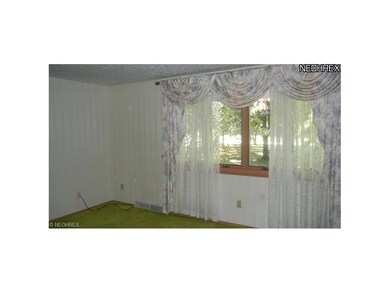 Large living room includes hardwood floors under t