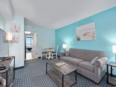 Living room featuring carpet floors and baseboards