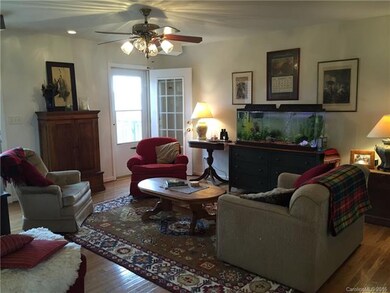 Living room has exterior chimney against back wall