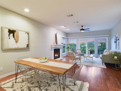 Dining room featuring a warm lit fireplace, ceili