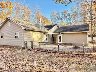 Rear view of house featuring a gate