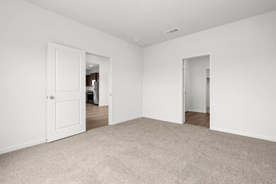 Empty room featuring light carpet and baseboards
