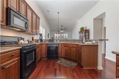 Kitchen with black appliances, vaulted ceiling, ki