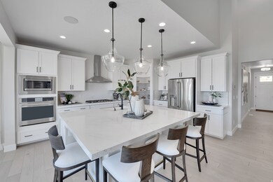 Kitchen featuring a kitchen breakfast bar, stainless steel appliances, backsplash, and recessed lighting